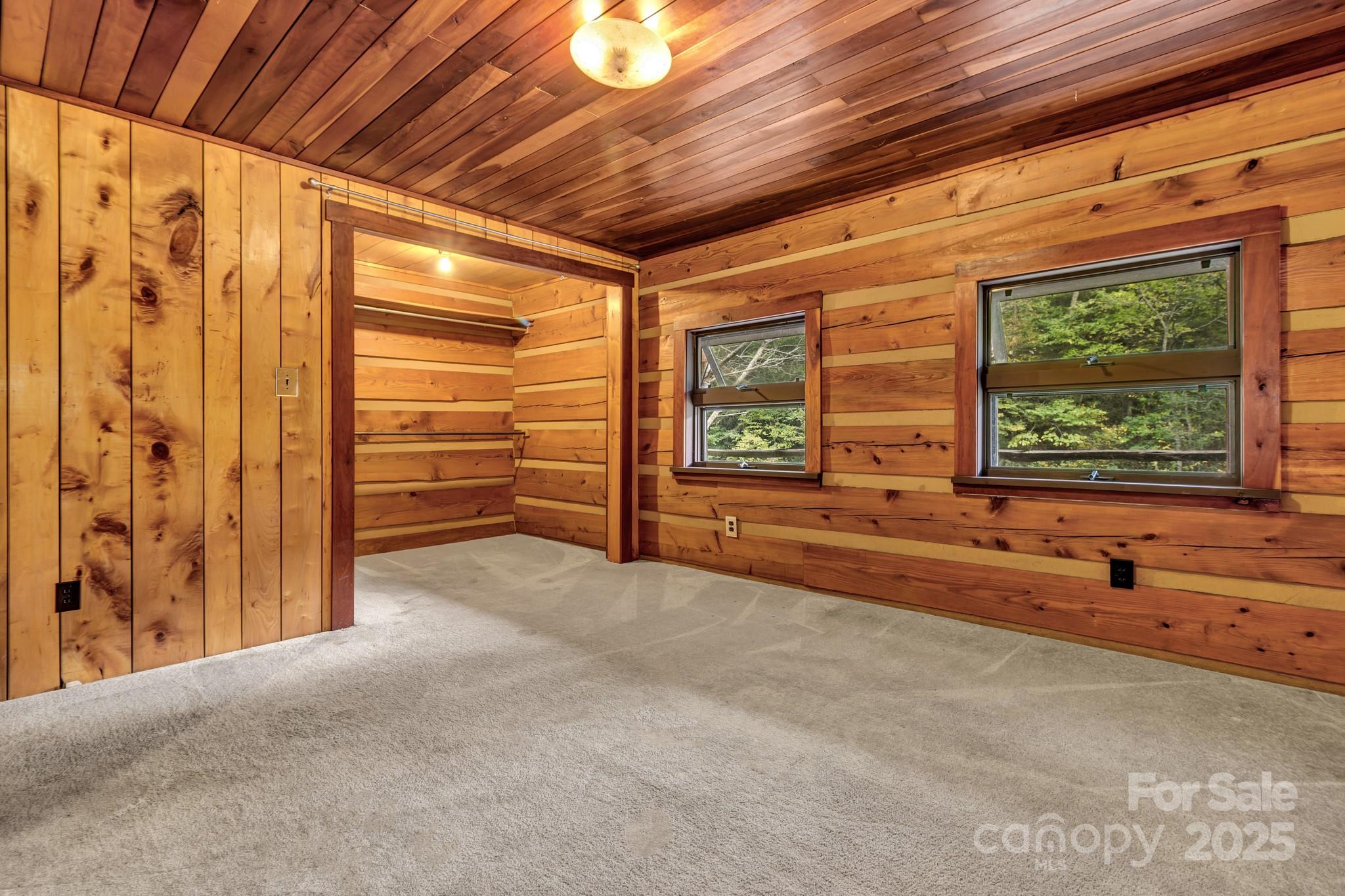 200 Dry Branch Road Marshall, NC 28753 - Photo 22 of 38 a view of an empty room with a birdcage and a window