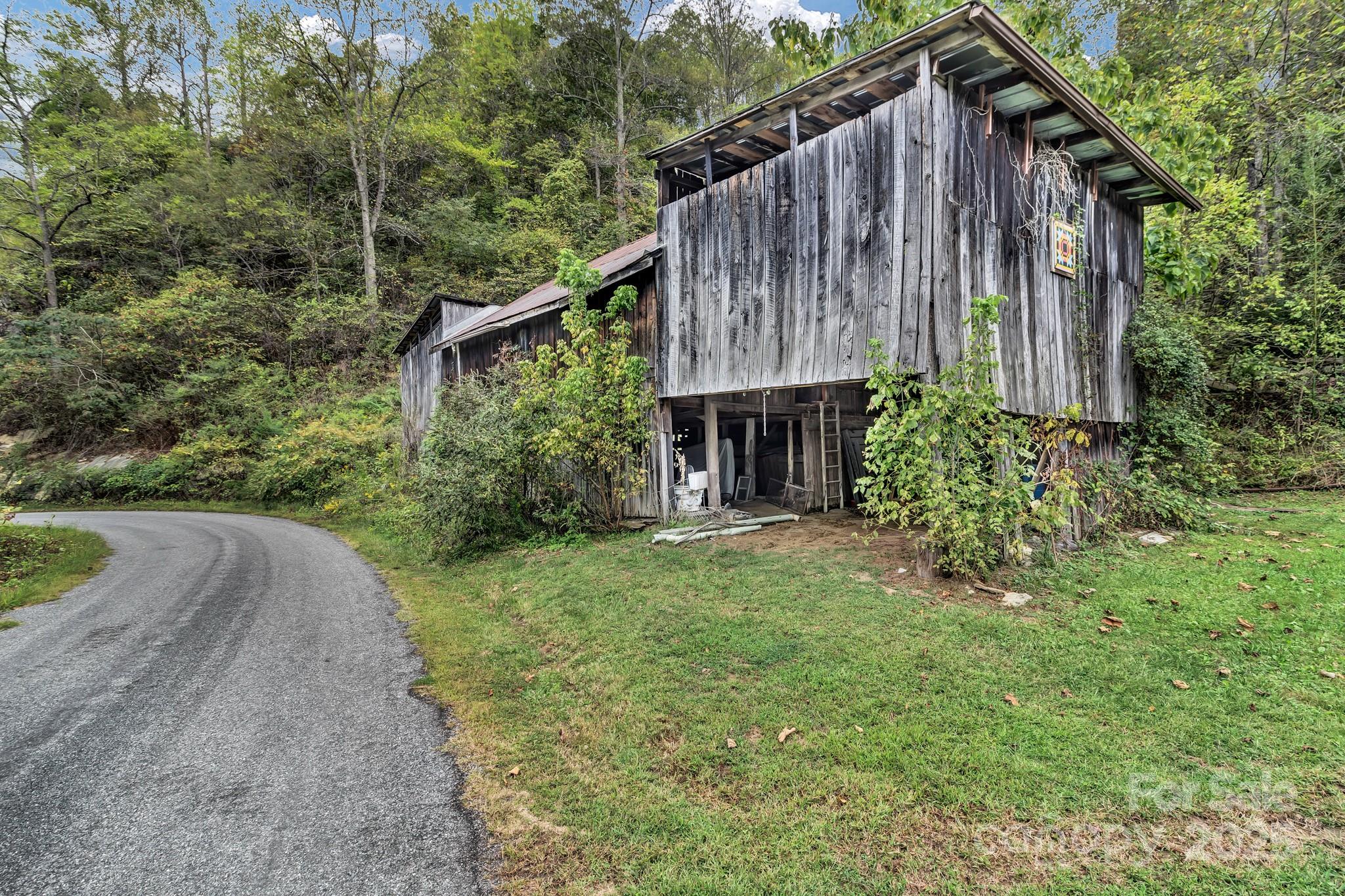 200 Dry Branch Road Marshall, NC 28753 - Photo 35 of 38 a backyard of a house with plants and tree with wooden fence