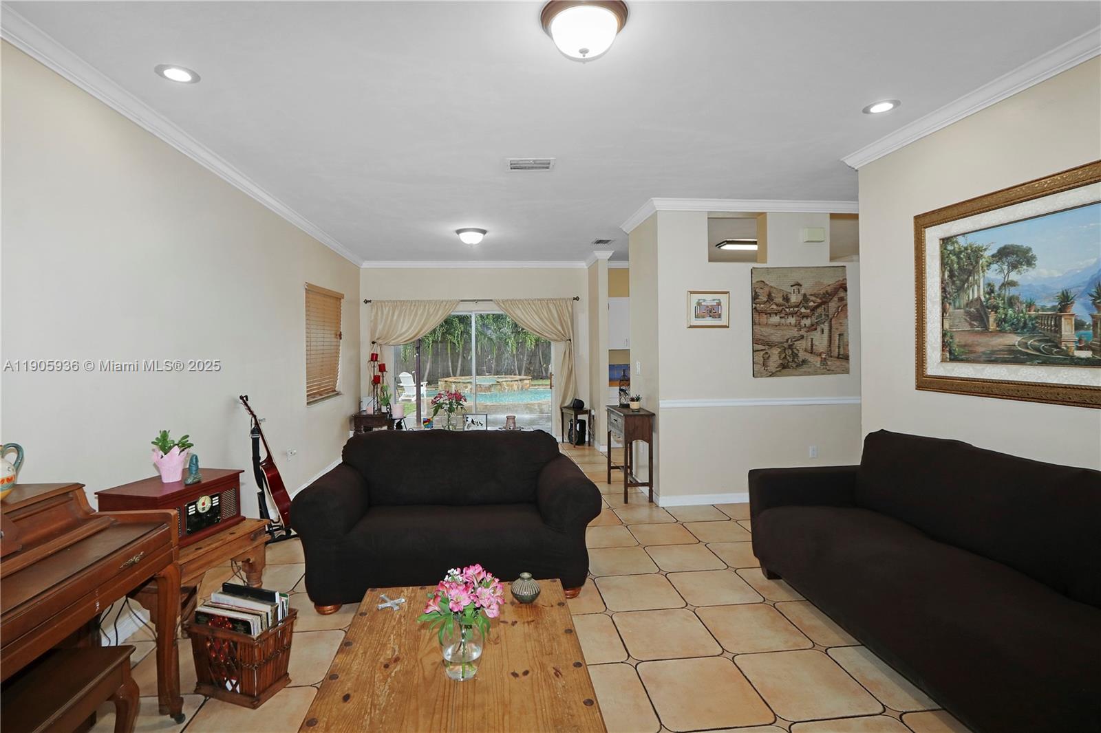 14723 Southwest 142nd Street Miami, FL 33196 - Photo 11 of 25 a living room with furniture and a large window