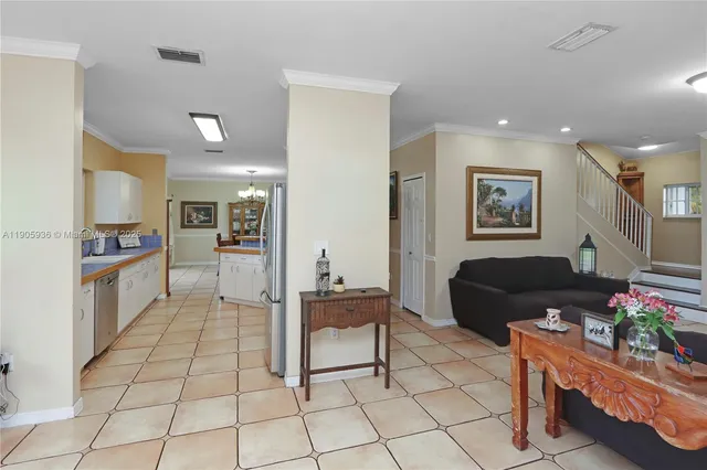 a living room with furniture and a kitchen