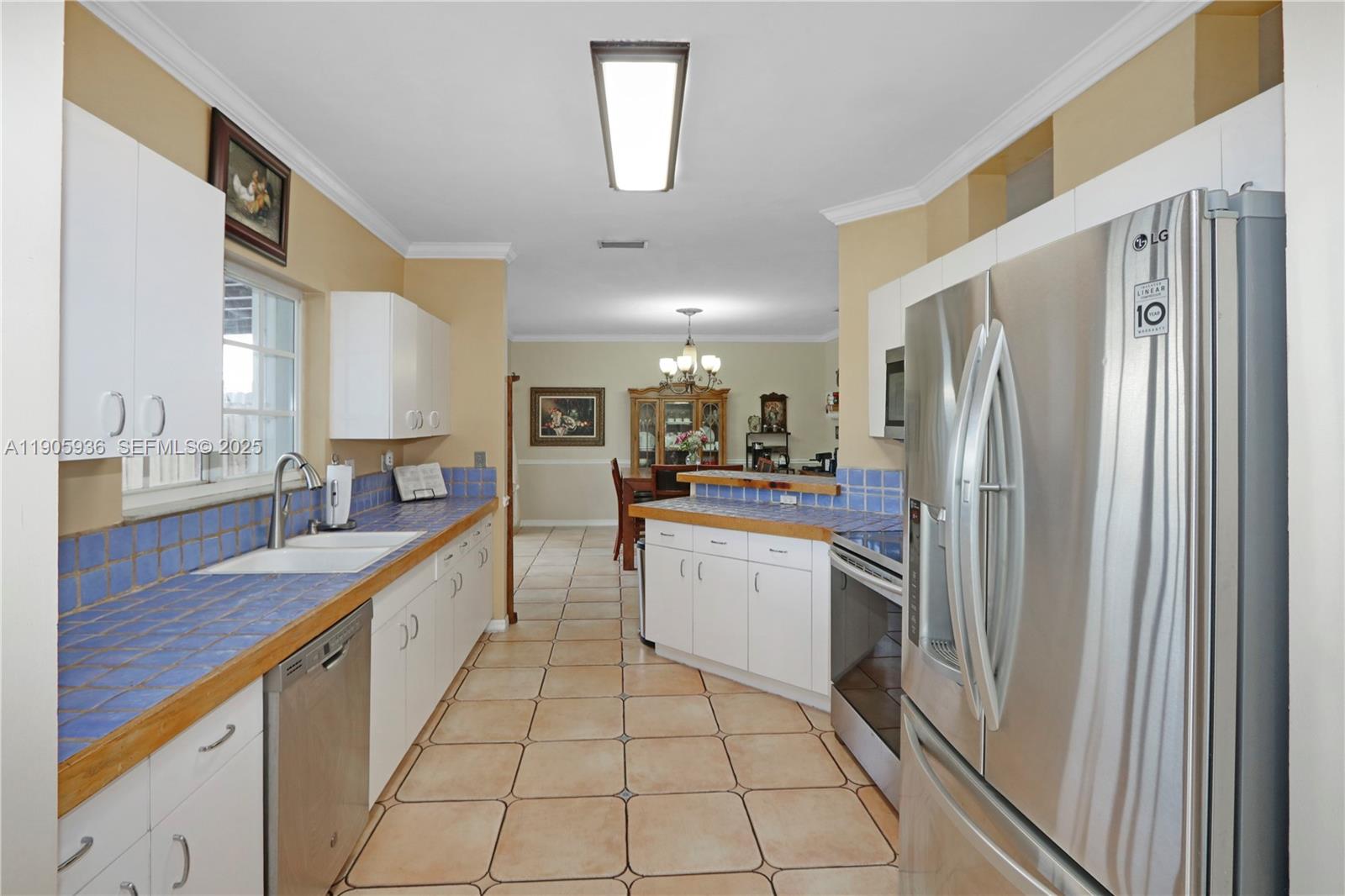 14723 Southwest 142nd Street Miami, FL 33196 - Photo 14 of 25 a kitchen with stainless steel appliances granite countertop a refrigerator and a sink