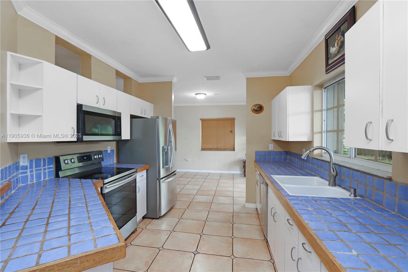 14723 Southwest 142nd Street Miami, FL 33196 - Photo 15 of 25 a kitchen with stainless steel appliances granite countertop a sink and a stove