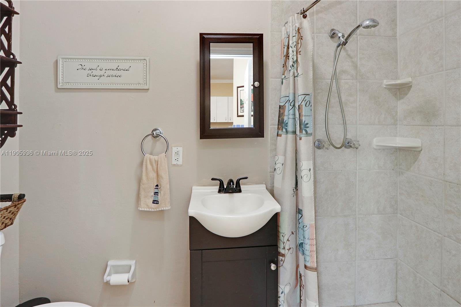 14723 Southwest 142nd Street Miami, FL 33196 - Photo 17 of 25 a bathroom with a sink a mirror and shower