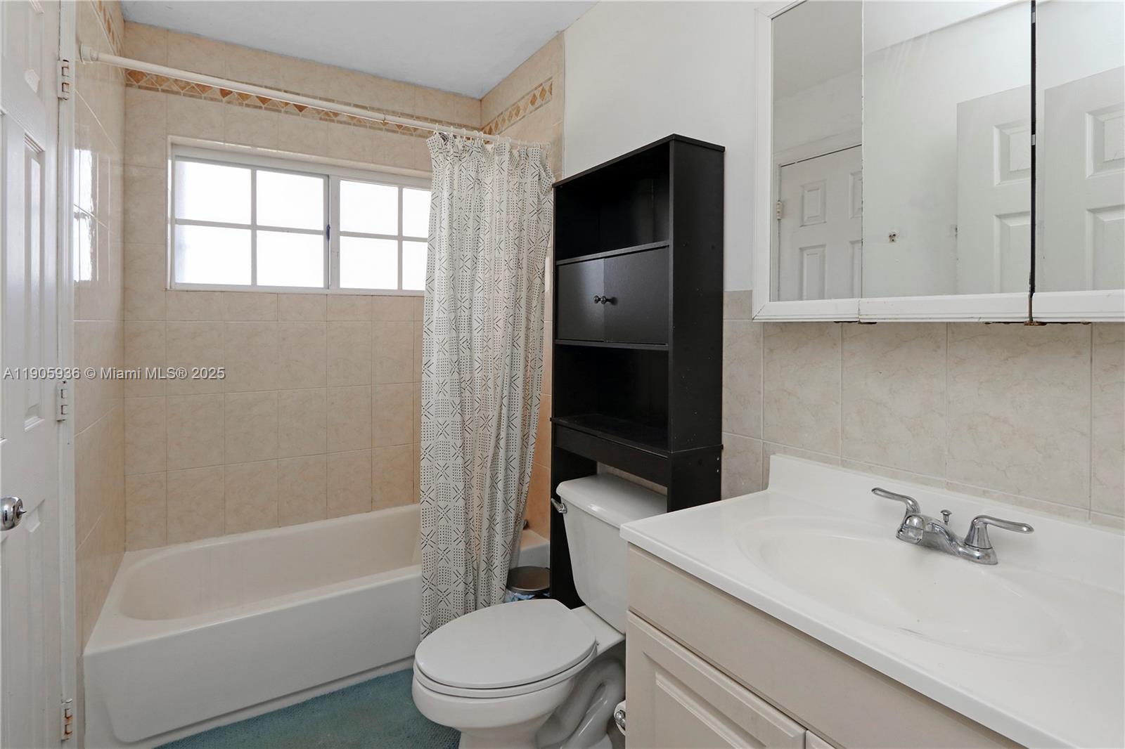 14723 Southwest 142nd Street Miami, FL 33196 - Photo 21 of 25 a bathroom with a sink toilet and shower