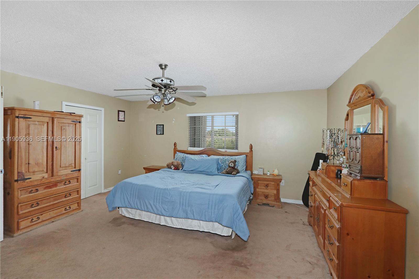 14723 Southwest 142nd Street Miami, FL 33196 - Photo 23 of 25 a bedroom with a bed and wooden floor