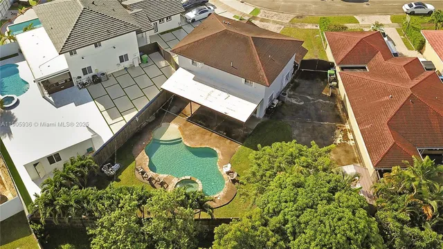 an aerial view of a house with a yard