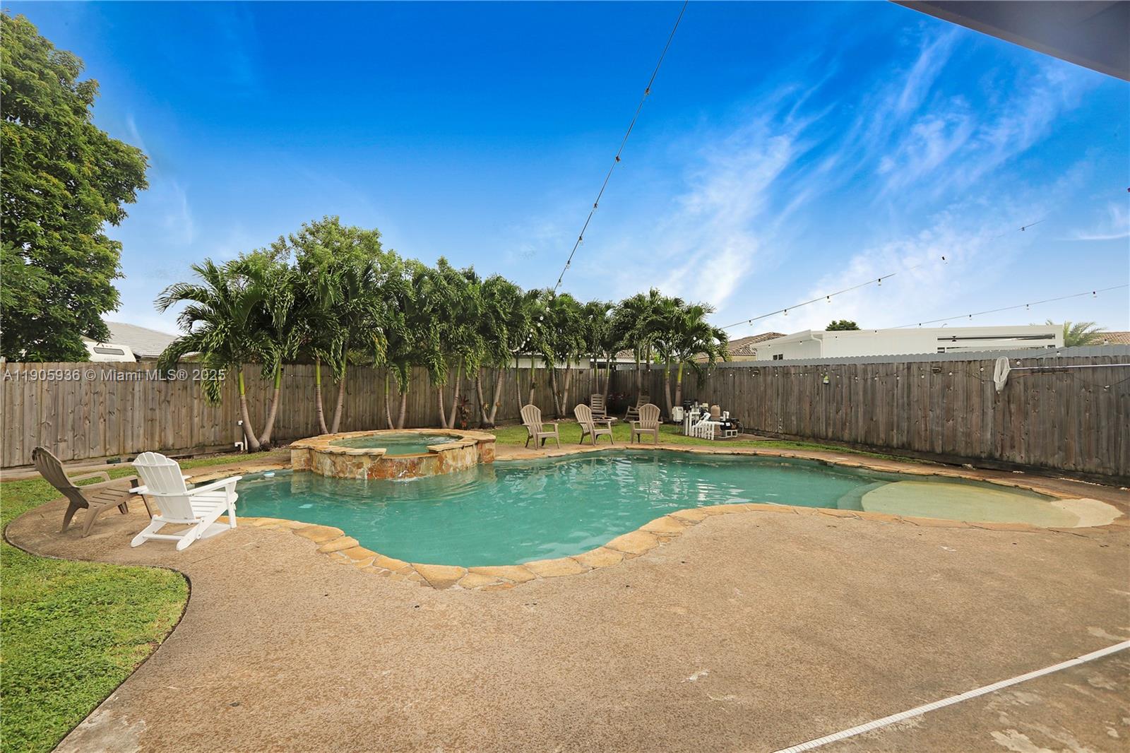 14723 Southwest 142nd Street Miami, FL 33196 - Photo 5 of 25 a view of a backyard with couches plants and large tree
