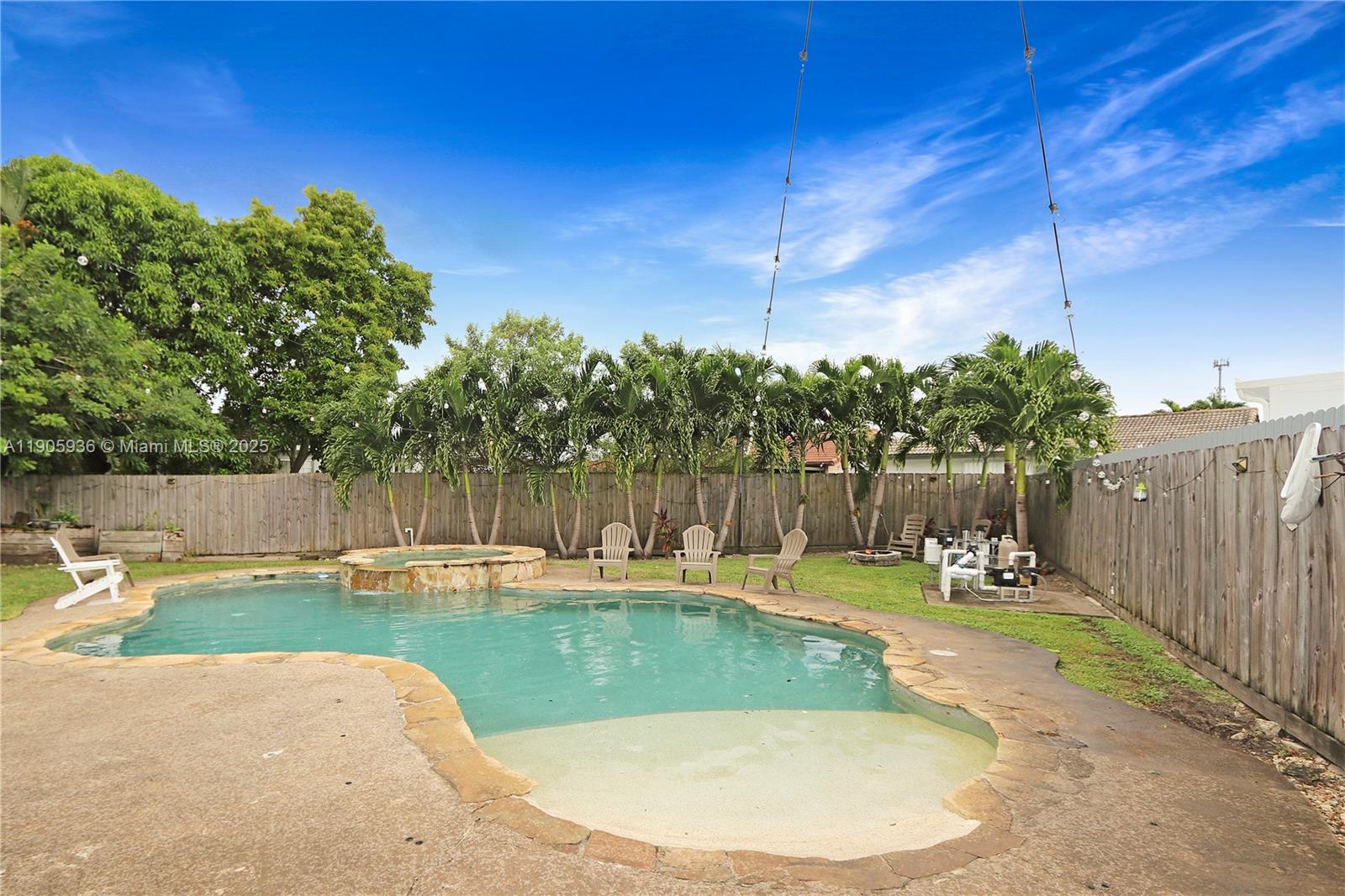 14723 Southwest 142nd Street Miami, FL 33196 - Photo 6 of 25 a view of a swimming pool with a patio