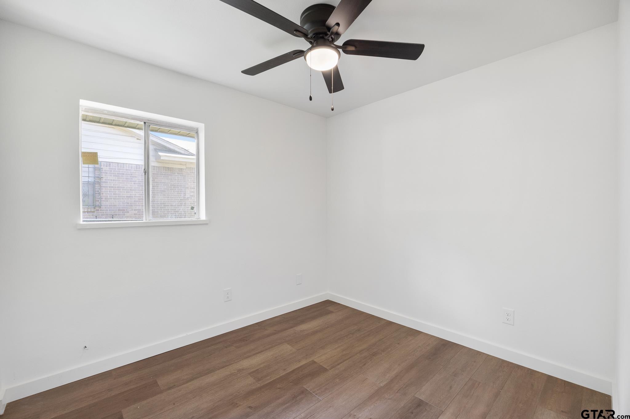 1538 North Hill Road Tyler, TX 75702 - Photo 18 of 29 an empty room with a window and a fan