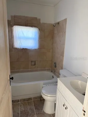 a bathroom with a toilet and a bathtub