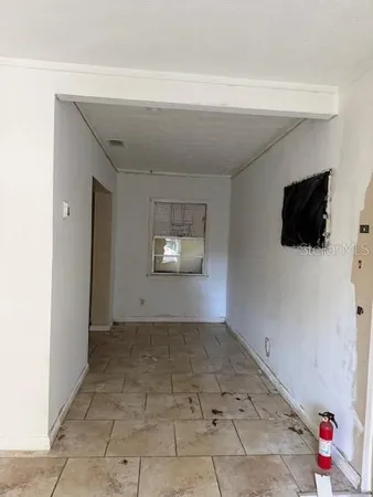 a view of a livingroom with wooden floor and a flat screen tv