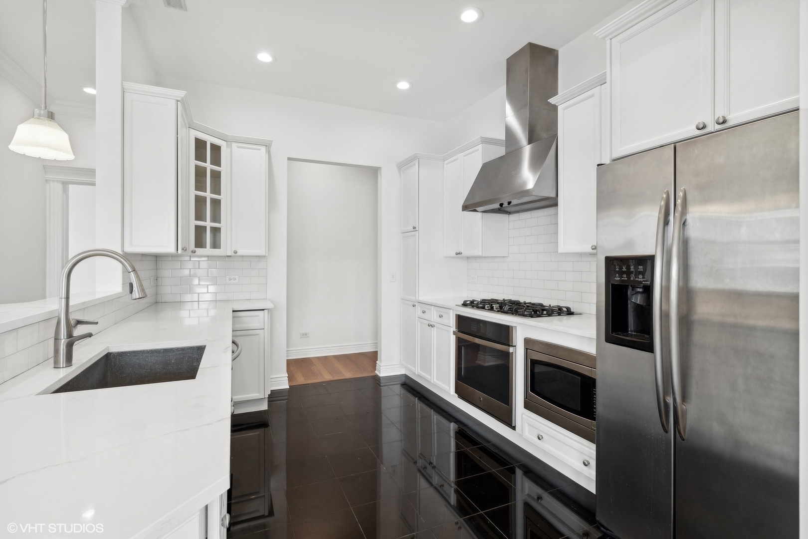 35 South Racine Avenue, Unit 4SW Chicago, IL 60607 - Photo 18 of 38 a kitchen with stainless steel appliances a stove a sink and a refrigerator