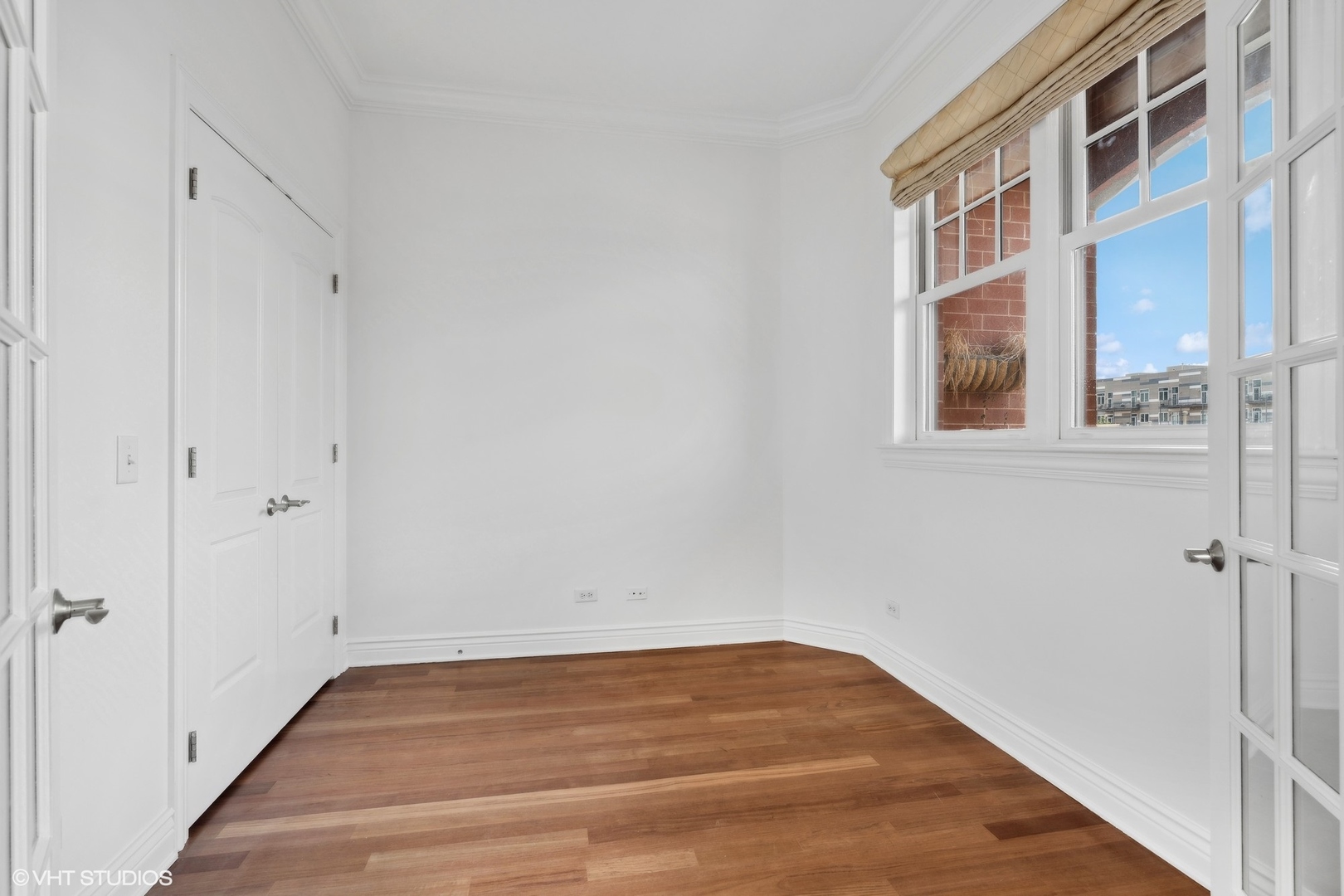 35 South Racine Avenue, Unit 4SW Chicago, IL 60607 - Photo 21 of 38 a view of an empty room with wooden floor and a hallway