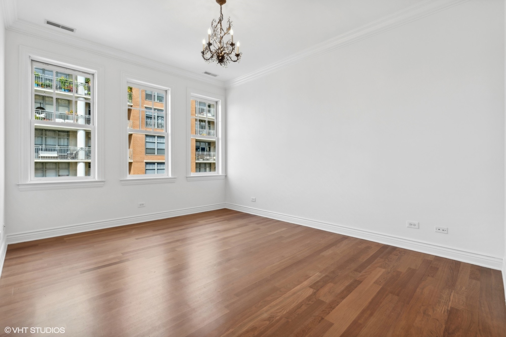 35 South Racine Avenue, Unit 4SW Chicago, IL 60607 - Photo 23 of 38 a view of an empty room with wooden floor and a window