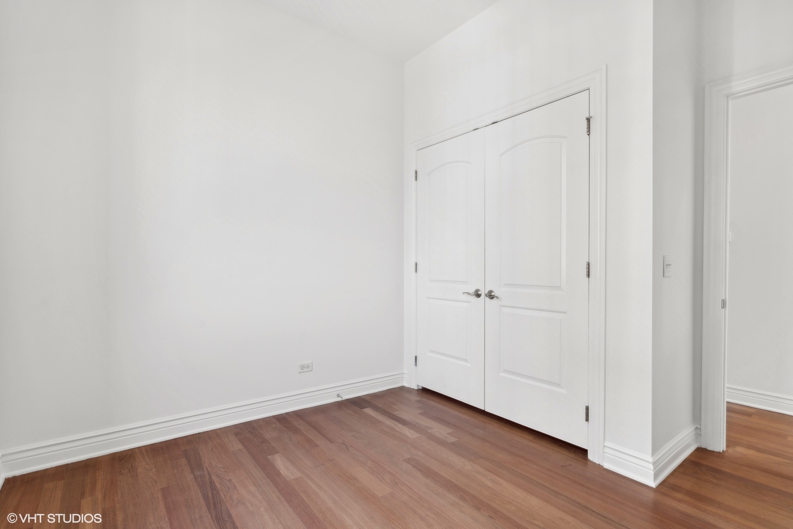 35 South Racine Avenue, Unit 4SW Chicago, IL 60607 - Photo 32 of 38 a view of an empty room with wooden floor