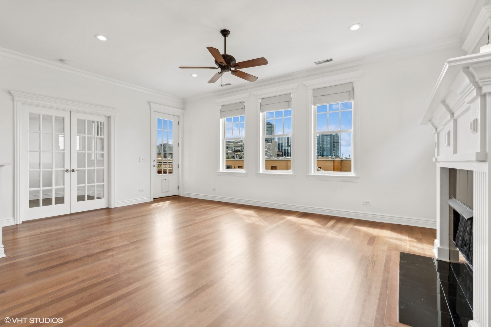 35 South Racine Avenue, Unit 4SW Chicago, IL 60607 - Photo 4 of 38 a view of an empty room with a window and wooden floor