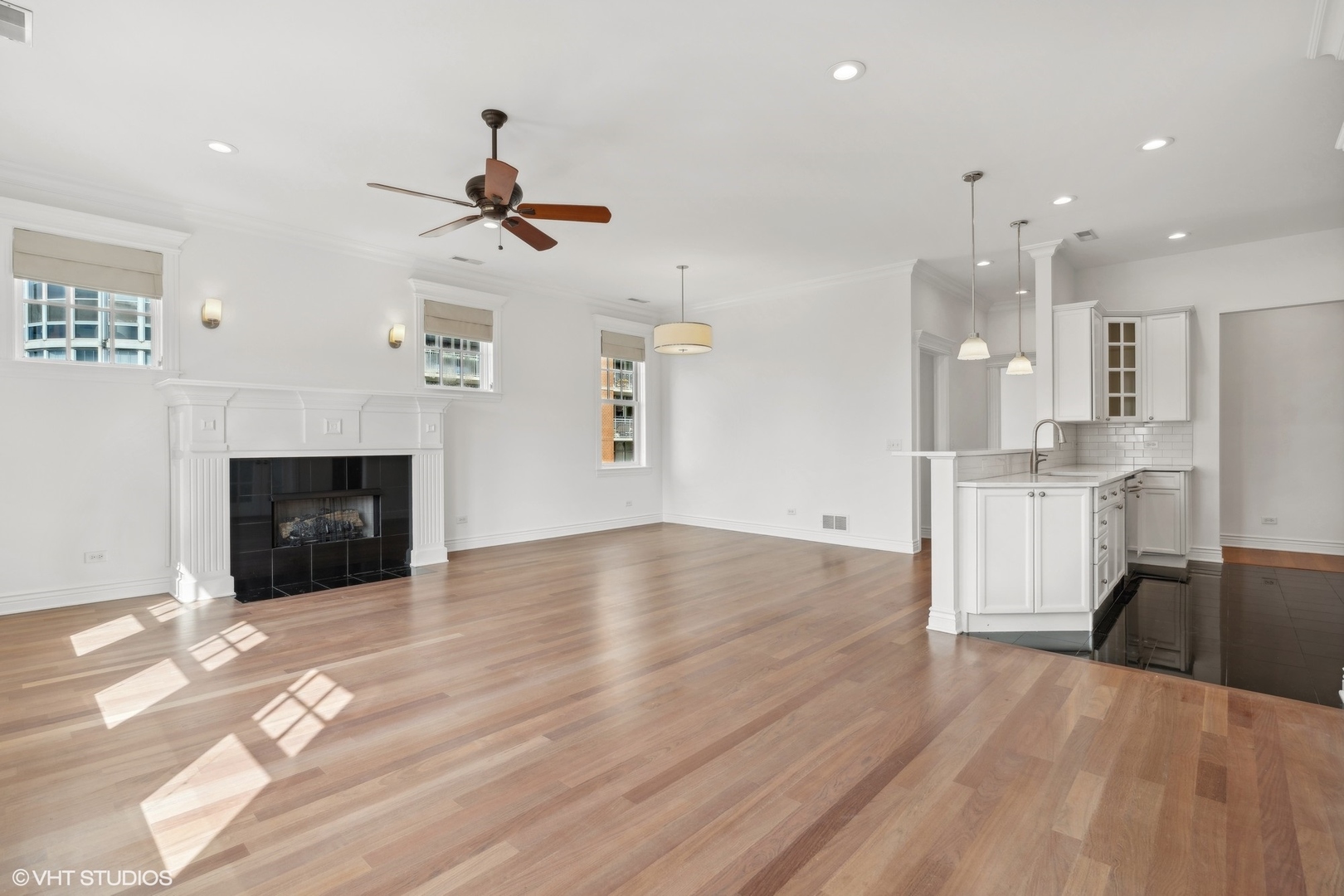 35 South Racine Avenue, Unit 4SW Chicago, IL 60607 - Photo 10 of 38 a view of a kitchen with wooden floor and a ceiling fan