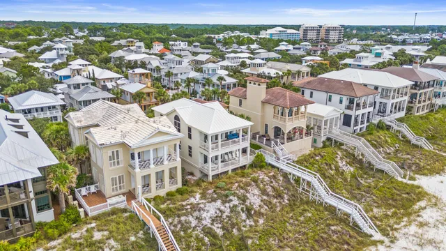 an aerial view of residential houses with yard
