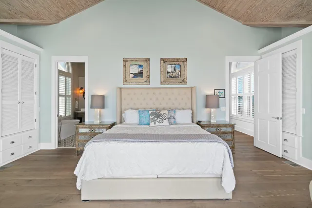 a spacious bedroom with a large bed and a large window