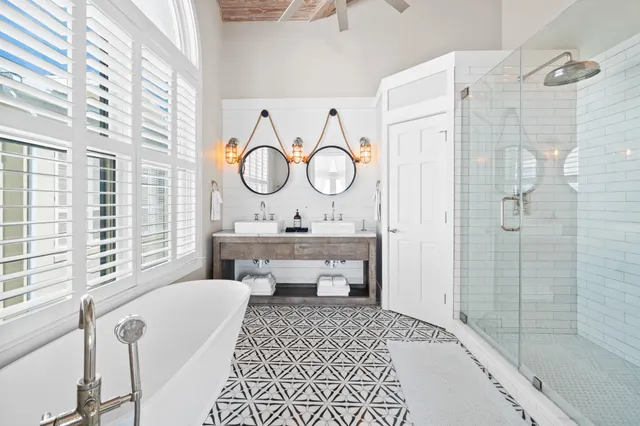 a bathroom with a granite countertop sink a mirror and a shower