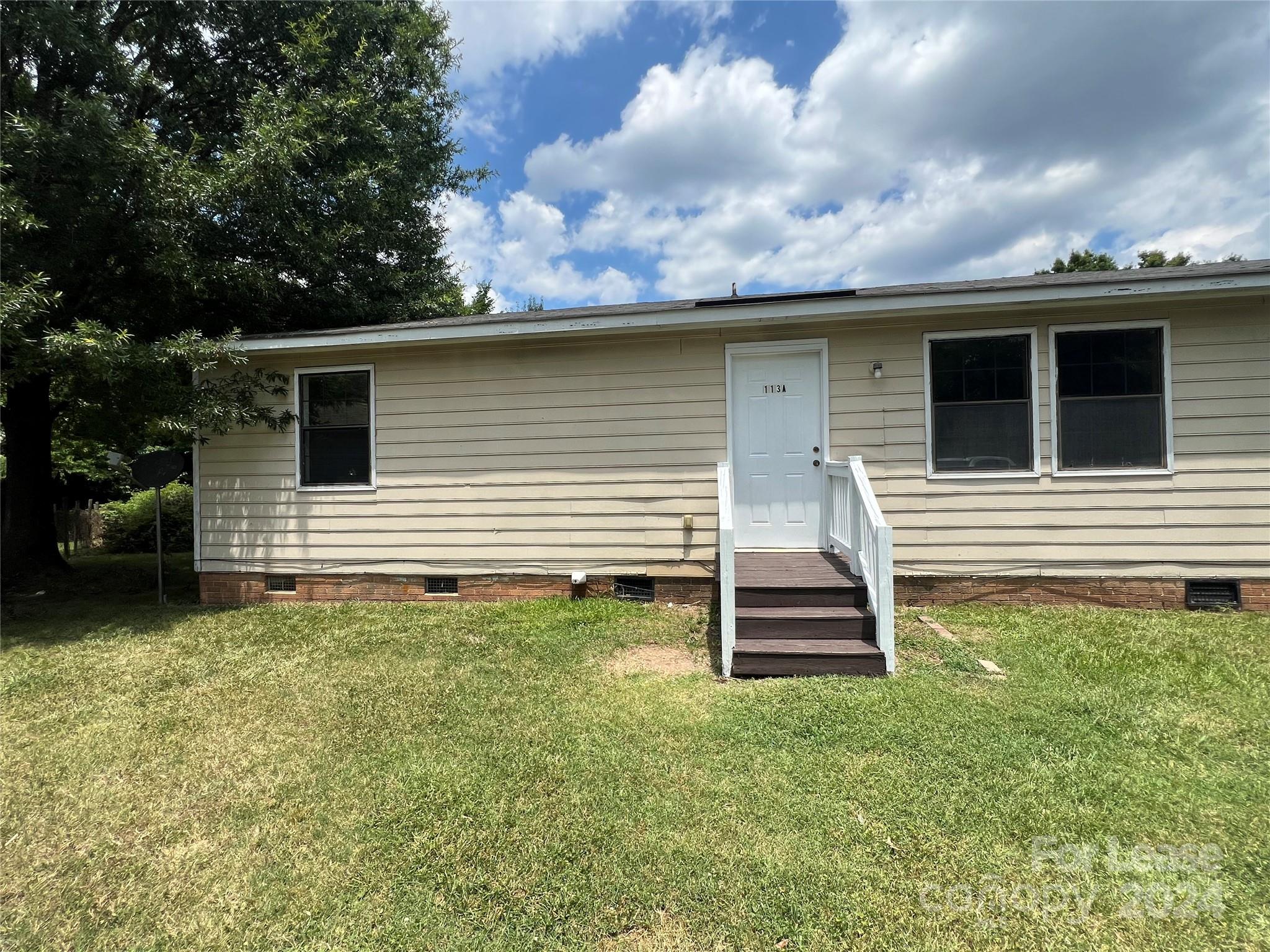 113 Drake Street, Unit A Gastonia, NC 28052 - Photo 1 of 8 a front view of a house with a yard