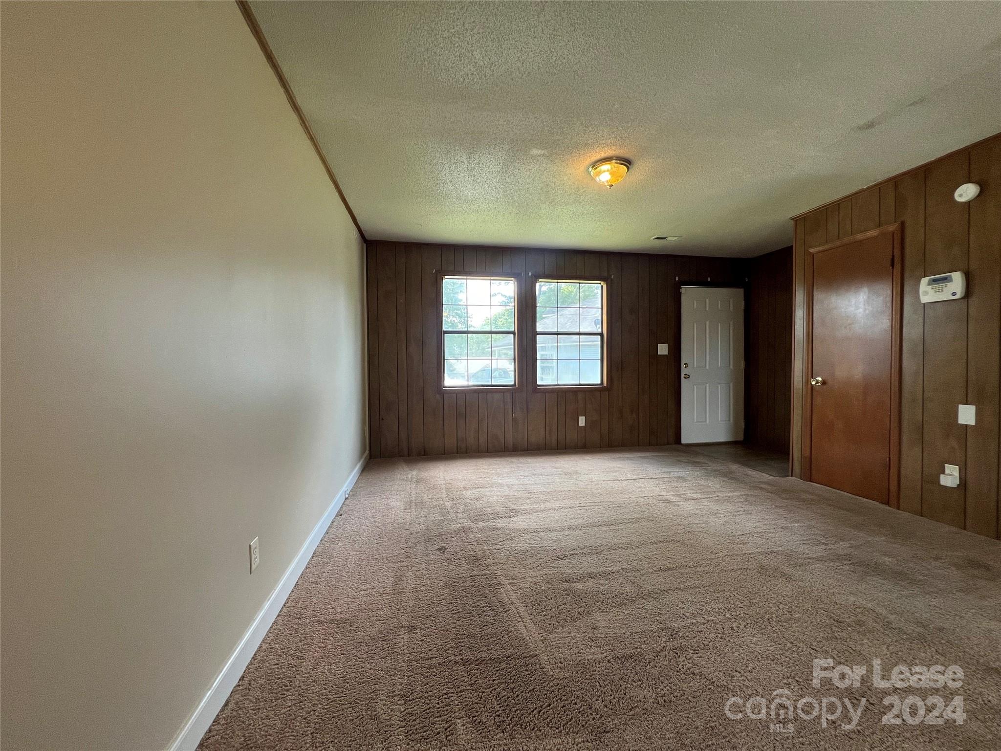 113 Drake Street, Unit A Gastonia, NC 28052 - Photo 2 of 8 a view of empty room with windows
