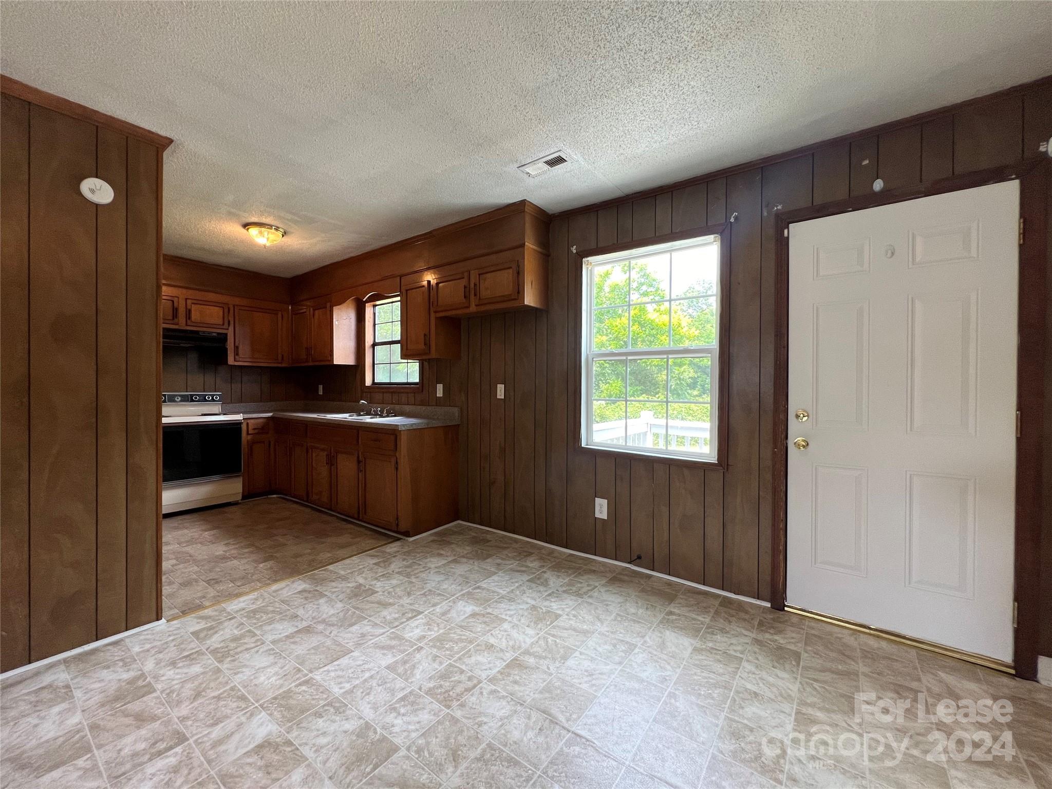 113 Drake Street, Unit A Gastonia, NC 28052 - Photo 3 of 8 a kitchen with stainless steel appliances granite countertop a refrigerator and a sink