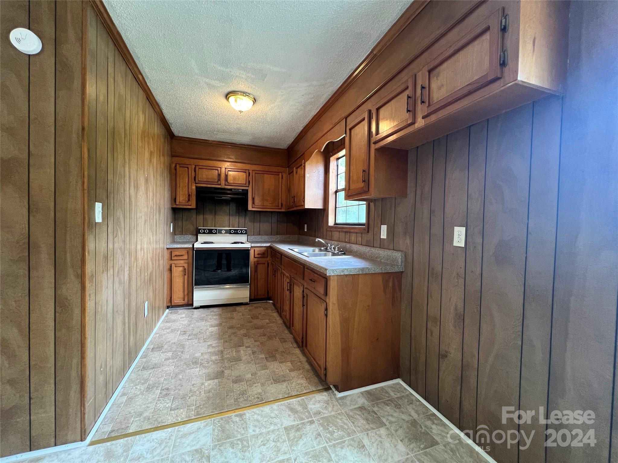 113 Drake Street, Unit A Gastonia, NC 28052 - Photo 4 of 8 a kitchen with stainless steel appliances granite countertop wooden cabinets a sink and a stove