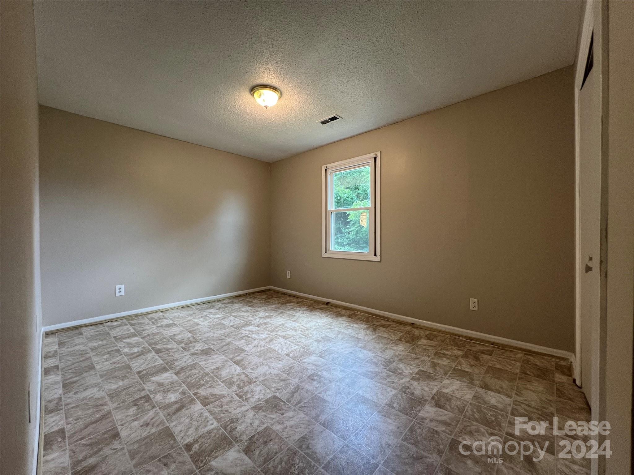 113 Drake Street, Unit A Gastonia, NC 28052 - Photo 6 of 8 a view of an empty room with a window