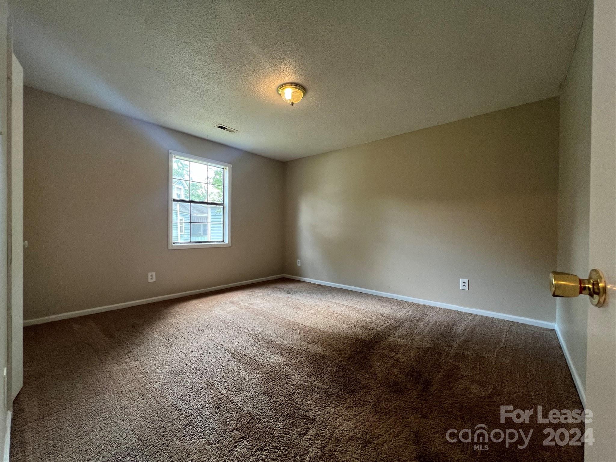 113 Drake Street, Unit A Gastonia, NC 28052 - Photo 8 of 8 a view of an empty room with a window