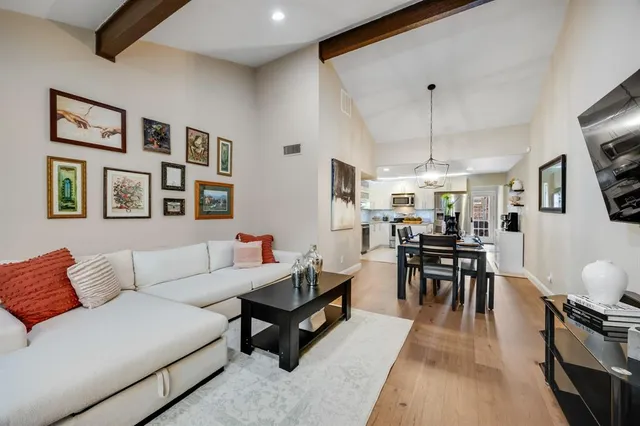 a living room with furniture a table and a flat screen tv