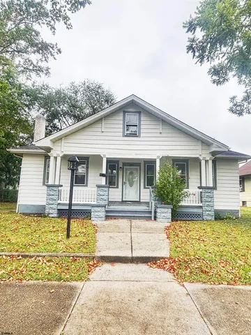 a front view of house with swimming pool and furniture
