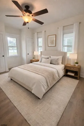 a bedroom with a bed chandelier and a window