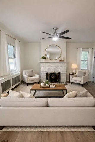 a living room with furniture a fireplace and window