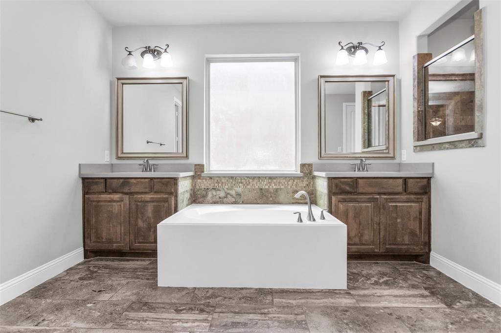 6333 Hall Road Frisco, TX 75034 - Photo 21 of 38 Dual vanities with stone countertops, deep soaking tub, and tile flooring
