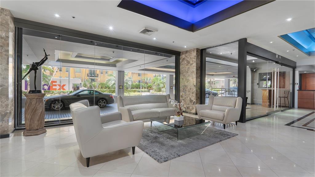 8877 Collins Avenue, Unit 1107 Surfside, FL 33154 - Photo 18 of 42 a living room with furniture large windows and wooden floor