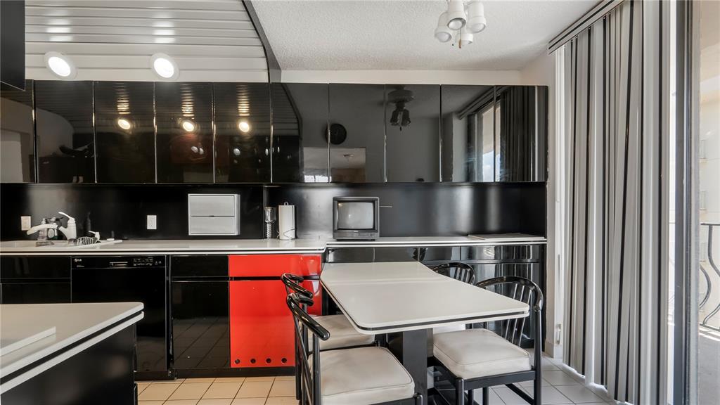 8877 Collins Avenue, Unit 1107 Surfside, FL 33154 - Photo 32 of 42 a kitchen with stainless steel appliances granite countertop a sink and cabinets