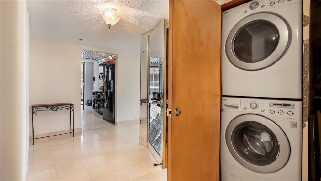 8877 Collins Avenue, Unit 1107 Surfside, FL 33154 - Photo 36 of 42 a view of a hallway with washer and dryer