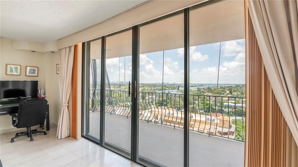 8877 Collins Avenue, Unit 1107 Surfside, FL 33154 - Photo 39 of 42 a view of a livingroom with workspace and a large window