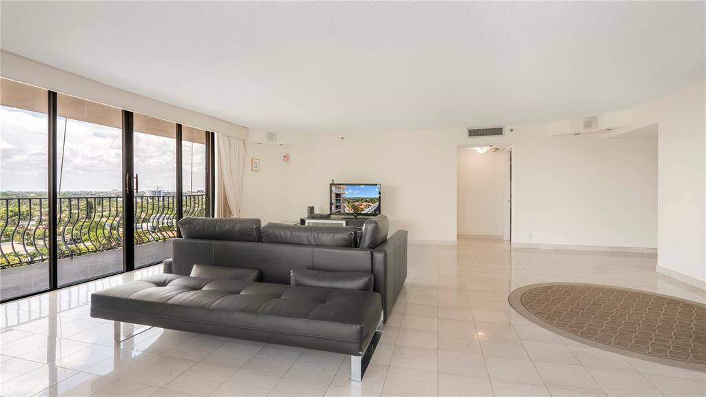 8877 Collins Avenue, Unit 1107 Surfside, FL 33154 - Photo 6 of 42 a living room with furniture and a large window