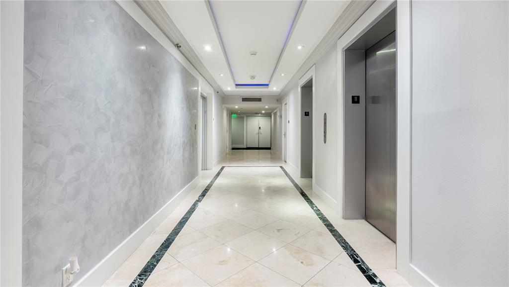 8877 Collins Avenue, Unit 1107 Surfside, FL 33154 - Photo 10 of 42 a view of a hallway with wooden floor