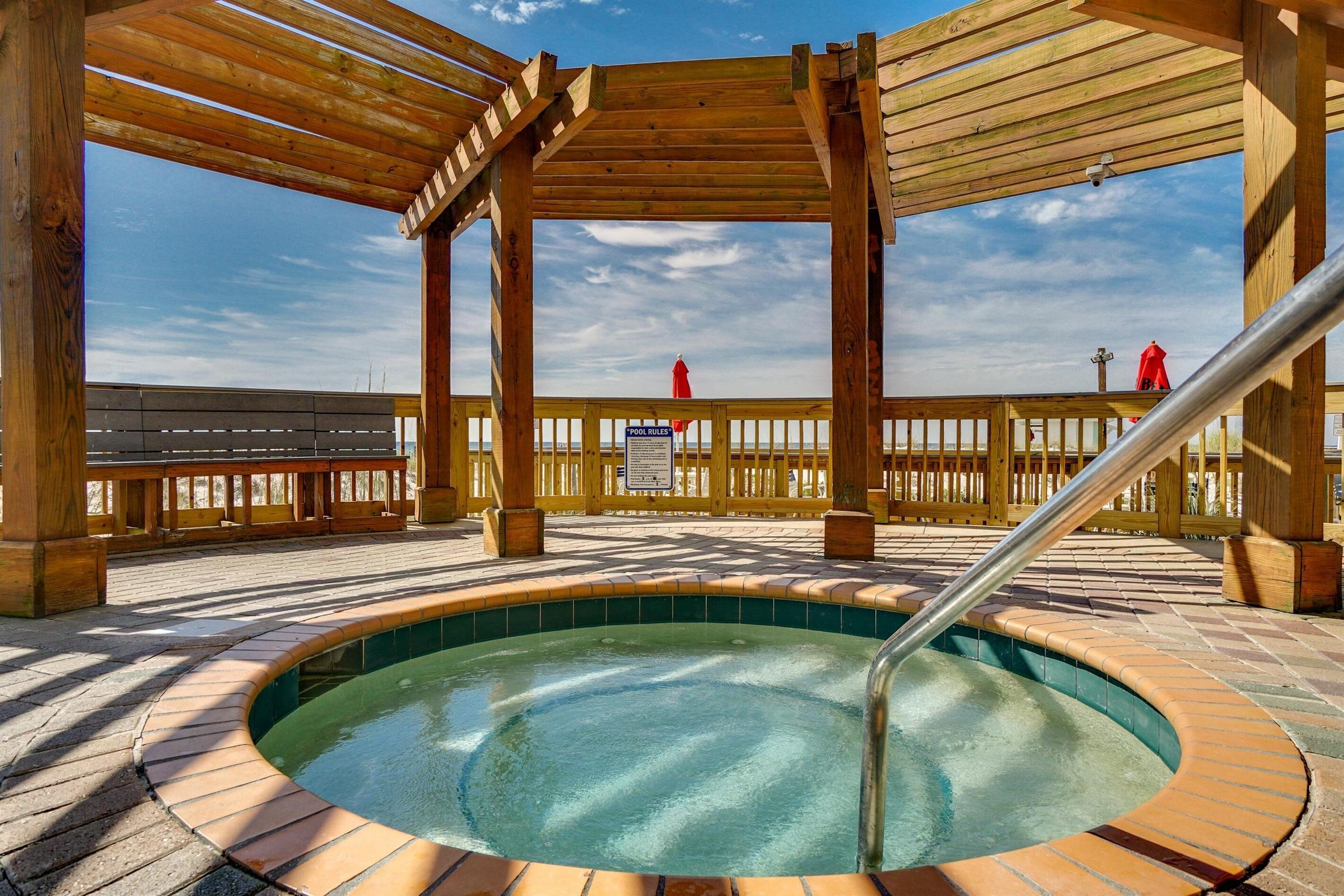 970 Highway 98, Unit 303 Destin, FL 32541 - Photo 41 of 42 a view of a swimming pool with a lounge chairs