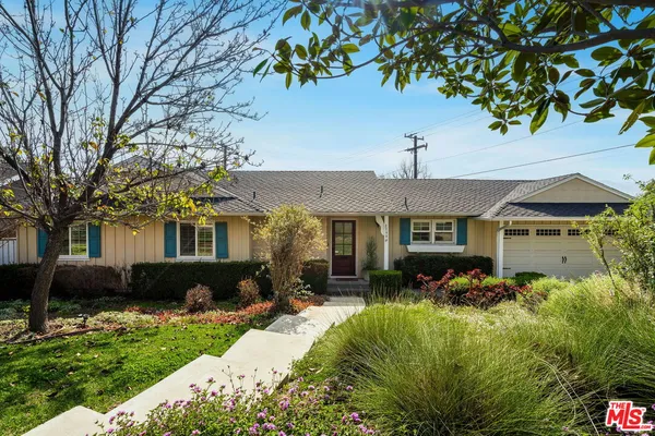 a front view of house with yard and trees