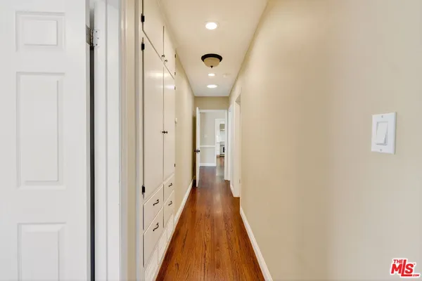 a view of a hallway with wooden floor