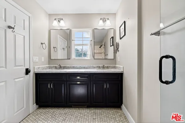 a bathroom with a sink a vanity and a mirror