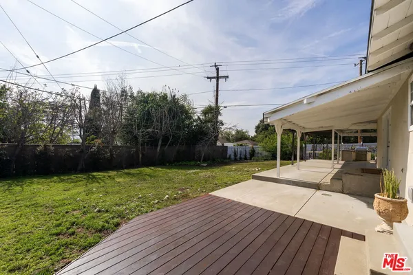 a view of a backyard with sitting area