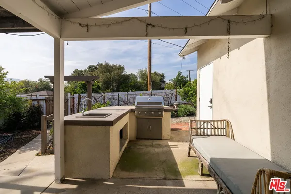 a view of a patio with a table and chairs