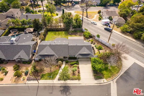 an aerial view of a house with a swimming pool