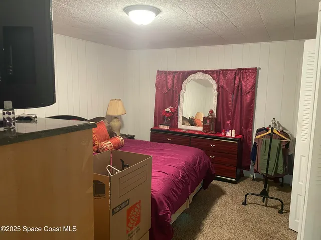 a bedroom with a bed and a table