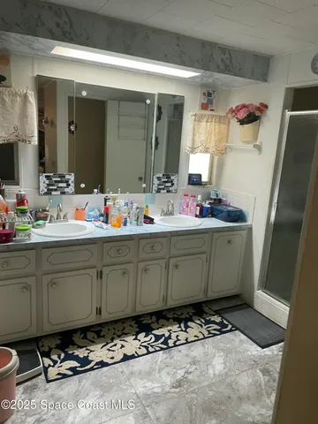 a bathroom with a sink mirror and a toilet